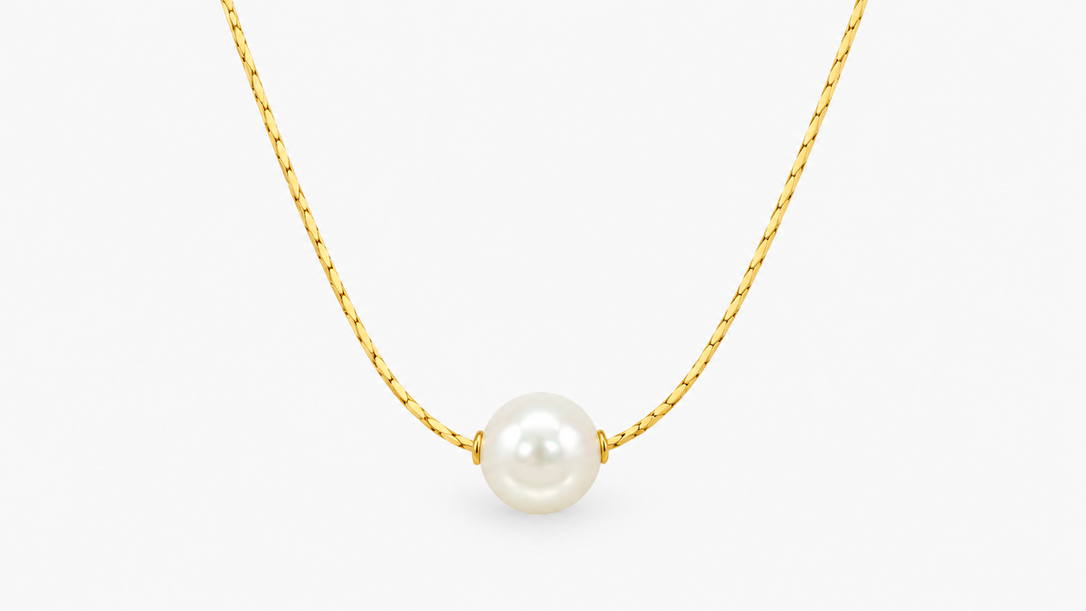 9.5mm Freshwater Pearl Solitaire Necklace in 9ct yellow gold, front view on a light grey background