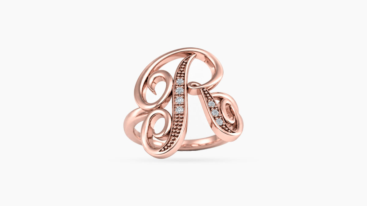 R diamond initial ring in polished rose gold, front view