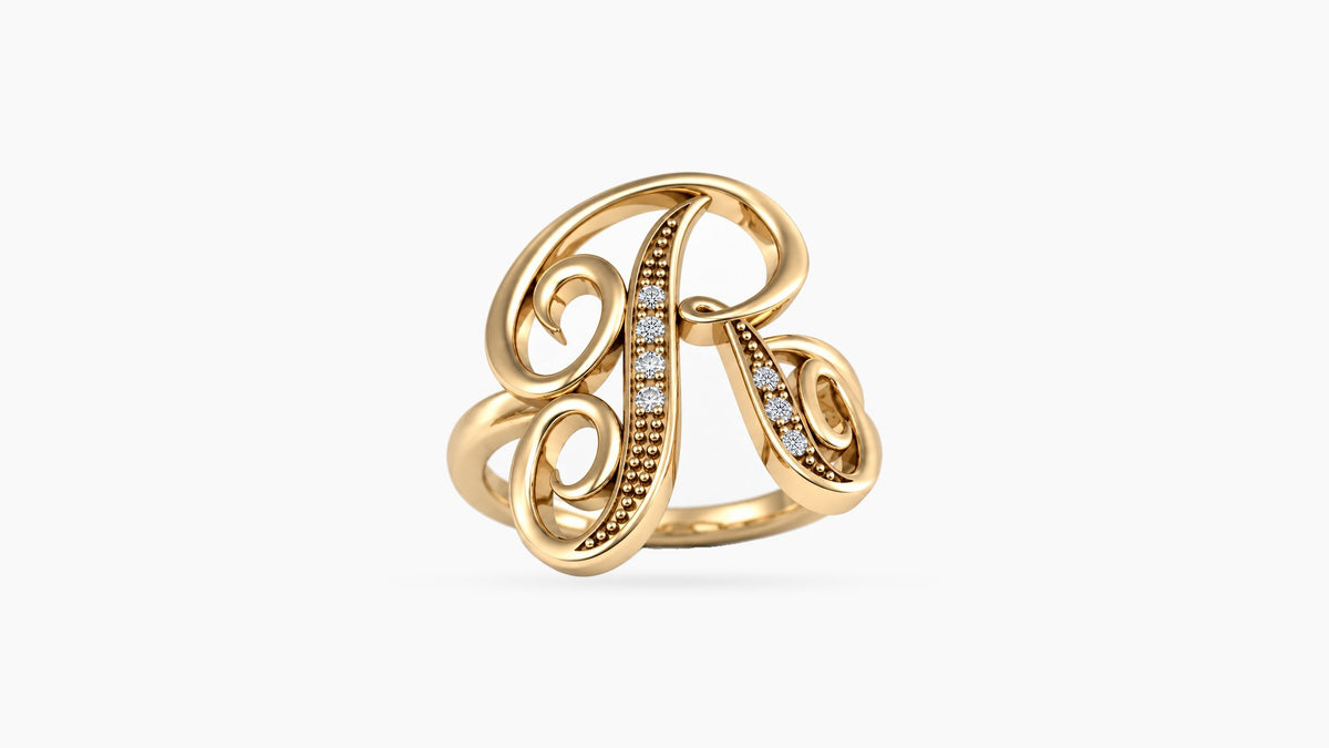 R diamond initial ring in polished yellow gold, front view