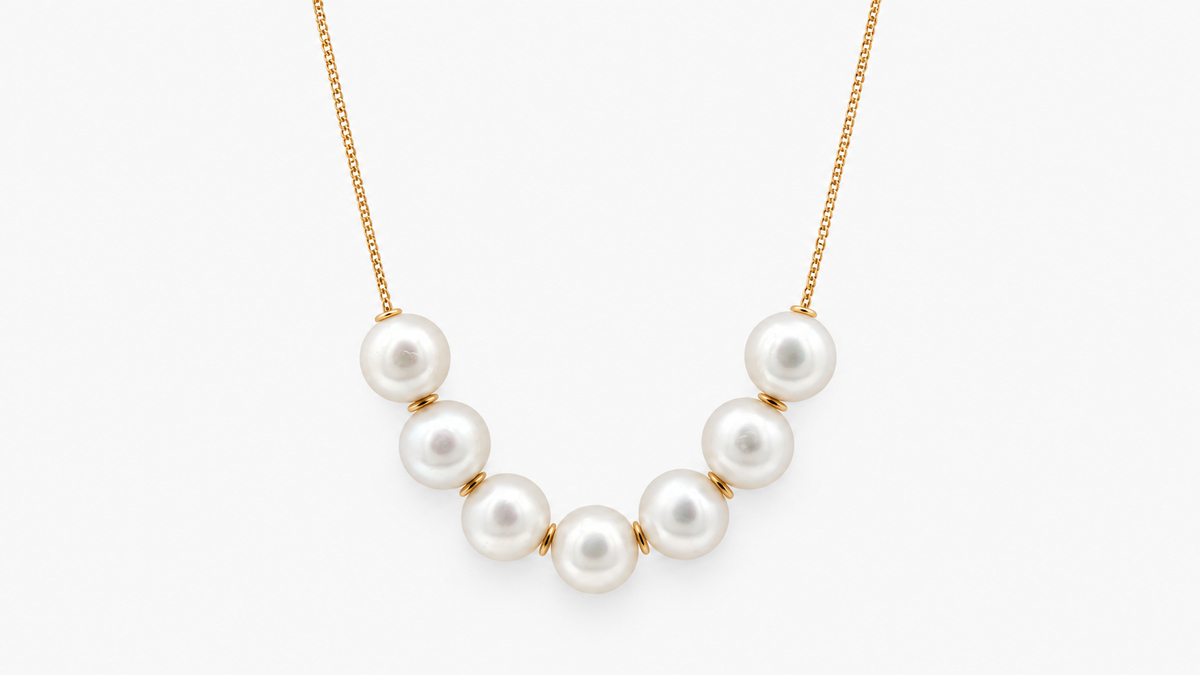 10mm Seven Pearl Necklace in 9ct yellow gold, front view on a light grey background